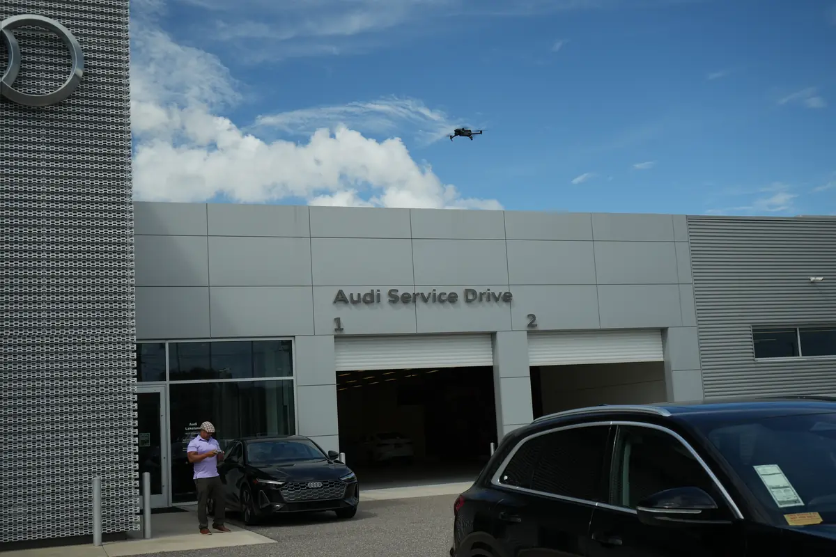 Drone filming the exterior of a dealership service drive