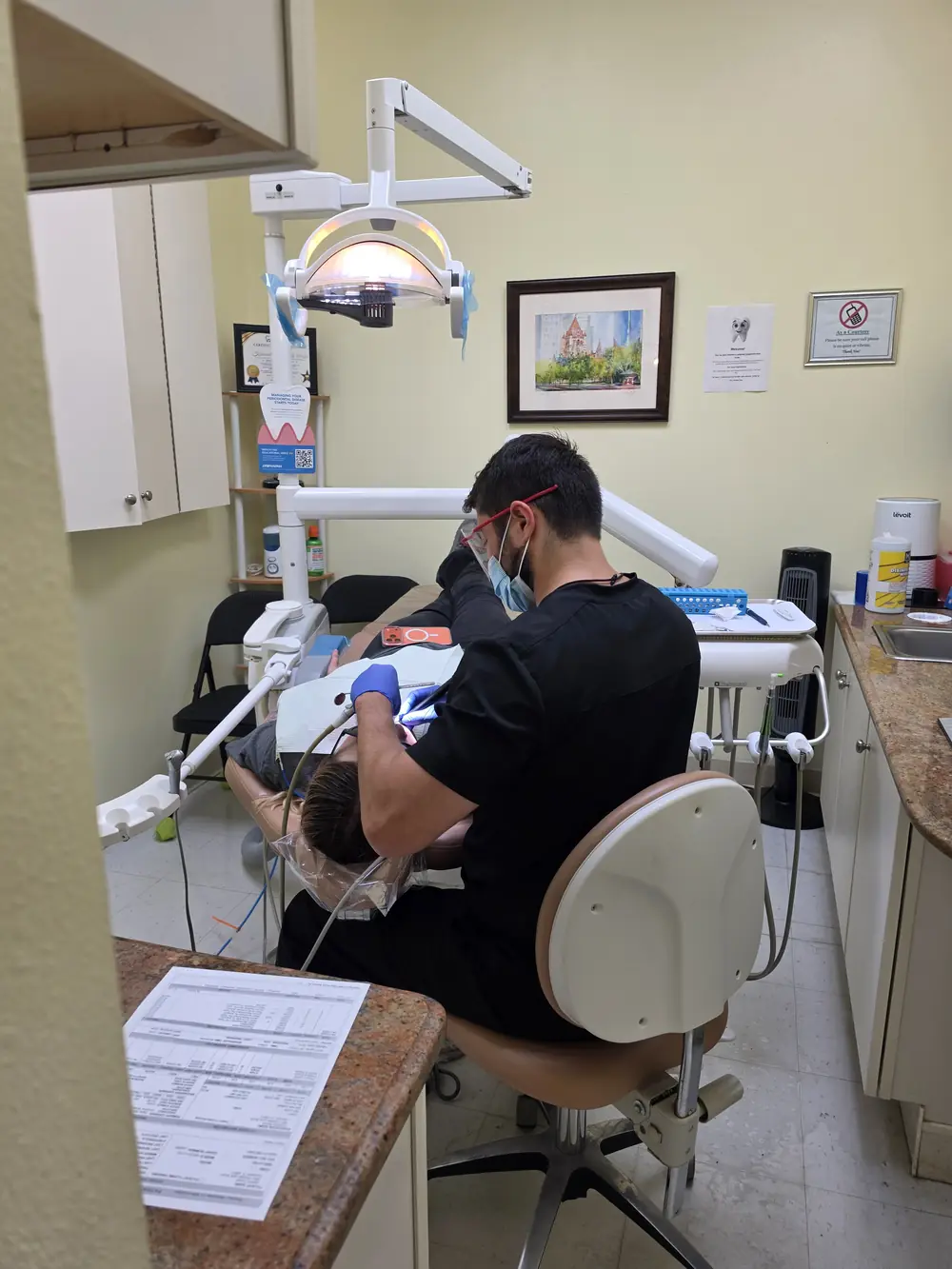 Dentist treating a patient during a content photo shoot at Highland Dental Plaza