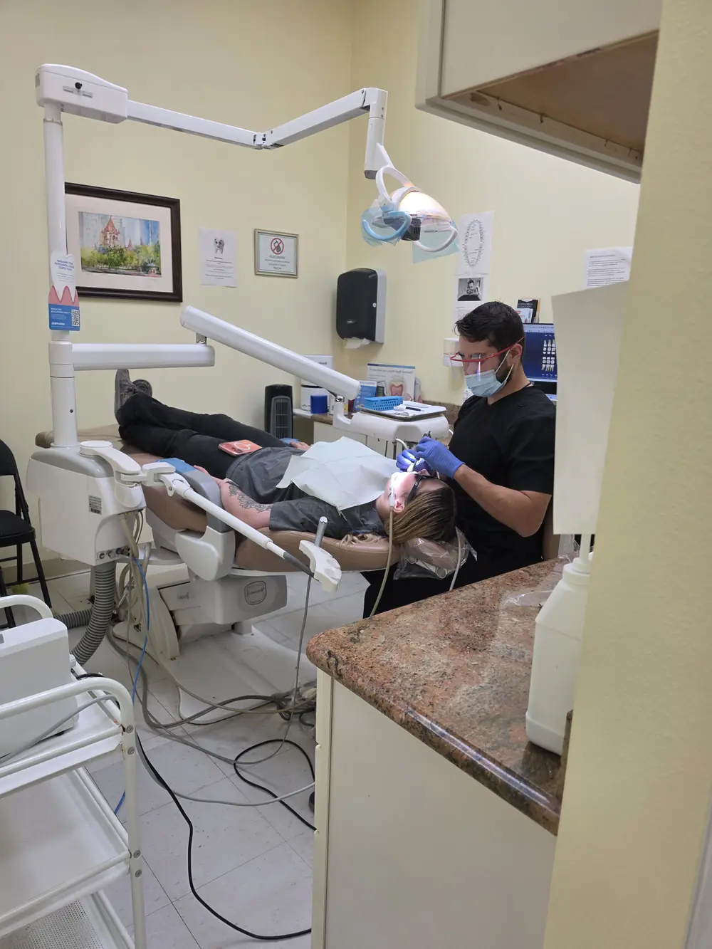 Dental team working with a patient during a content shoot