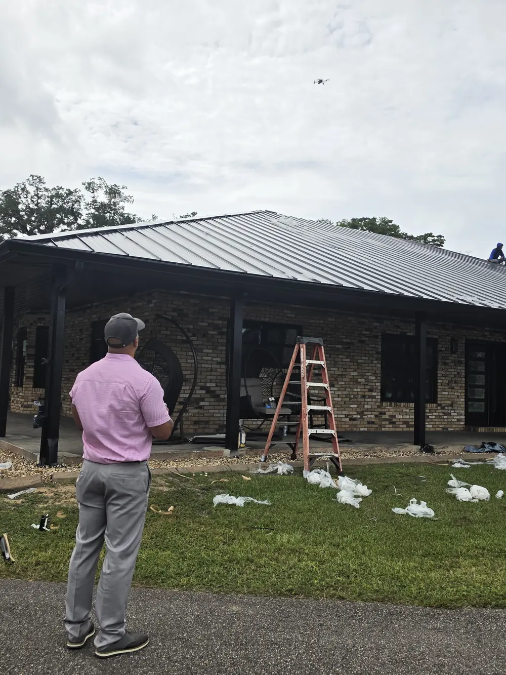 Roofing technician flying a drone to inspect a roof