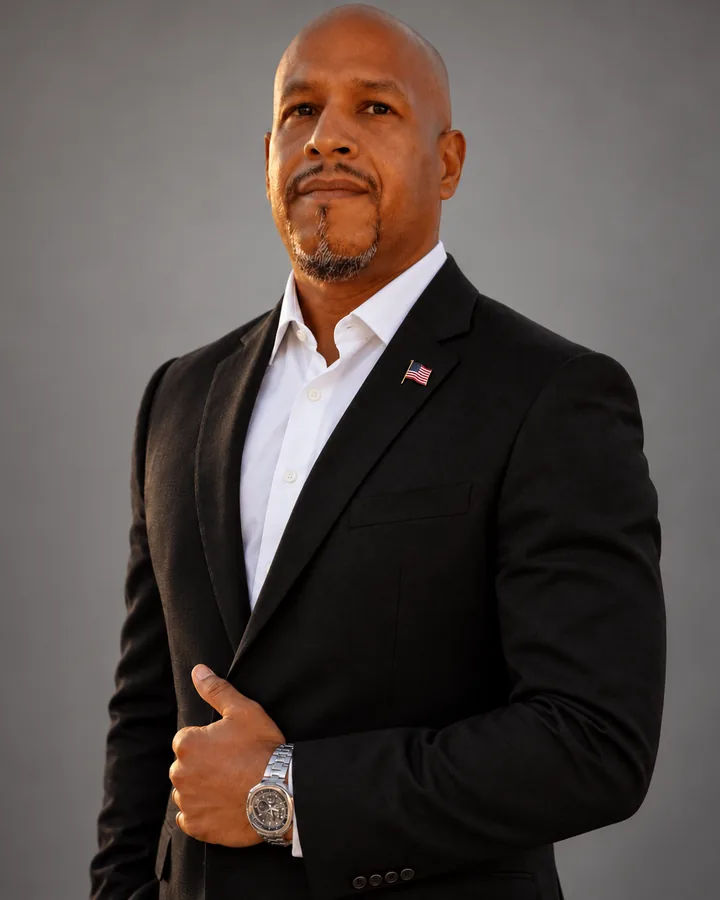 Portrait of Michael Texidor, Chief Executive Officer of Insight Pros, in a dark suit